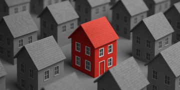 Mutui e mercato immobiliare in Italia rappresentati da una casa rossa tra abitazioni grigie